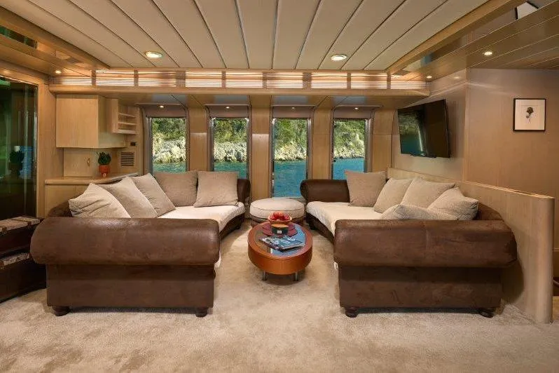  Yacht Photos Pics Luxurious interior of 1992 Posillipo Technema 82 yacht with plush seating and scenic windows.