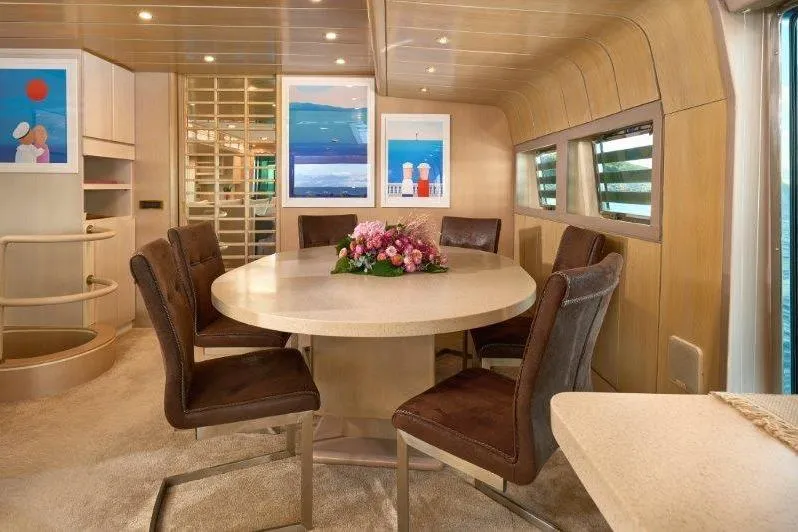  Yacht Photos Pics Luxurious dining area inside a 1992 Posillipo Technema 82 yacht, featuring elegant decor and artwork.