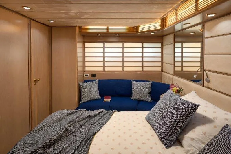  Yacht Photos Pics Luxurious bedroom interior of 1992 Posillipo Technema 82 yacht with elegant wood paneling.