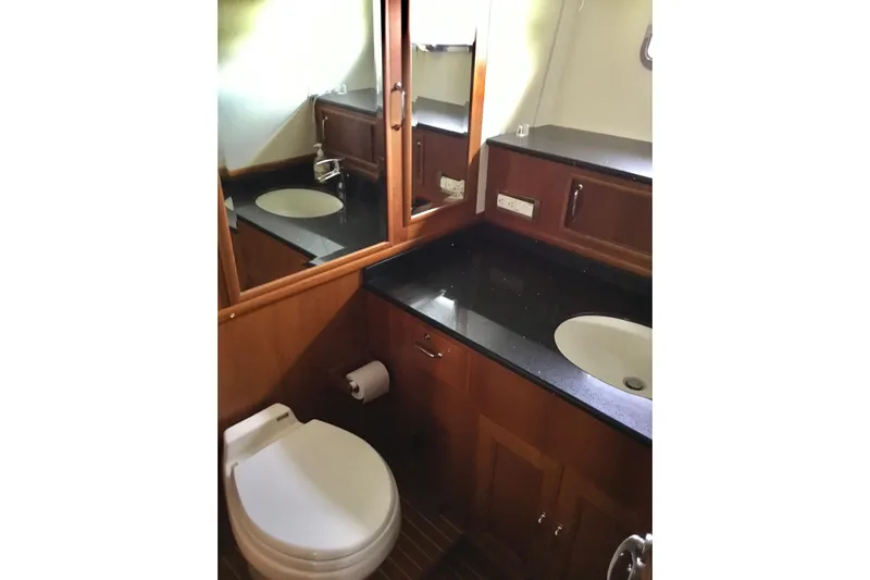 "journeys" Yacht Photos Pics Luxurious bathroom in 2008 Grand Banks 59 Aleutian RP yacht with elegant wood cabinetry.