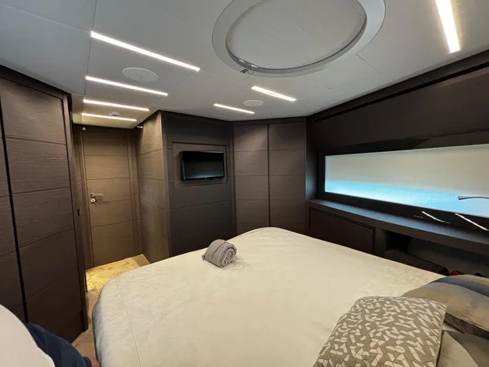  Yacht Photos Pics Luxurious bedroom interior of 2019 Pershing 74 yacht with modern design and ambient lighting.