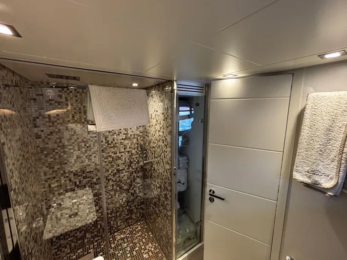  Yacht Photos Pics Luxurious bathroom in 2019 Pershing 74 yacht with mosaic-tiled shower and modern fixtures.