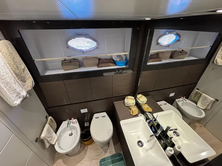  Yacht Photos Pics Luxurious bathroom interior of 2019 Pershing 74 yacht with dual sinks and modern fixtures.