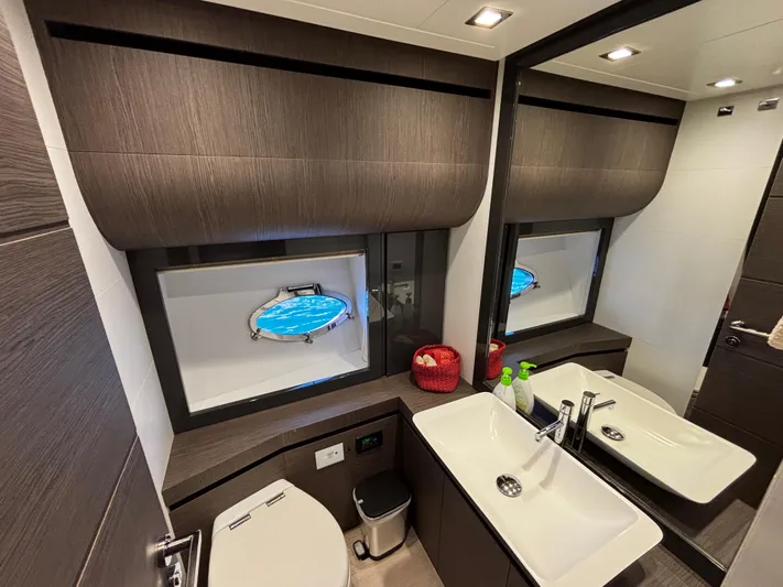  Yacht Photos Pics Luxurious bathroom interior of 2019 Pershing 74 yacht with modern fixtures and ocean view.
