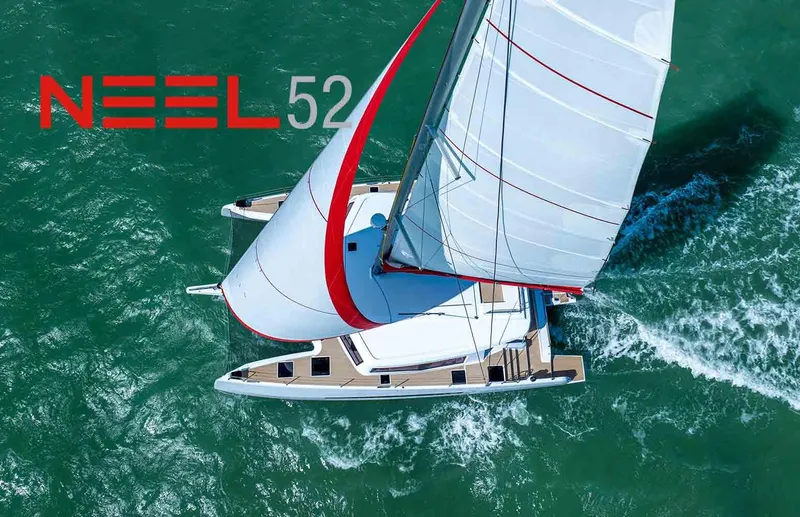  Yacht Photos Pics Aerial view of 2025 NEEL 52 trimaran sailing on turquoise waters.