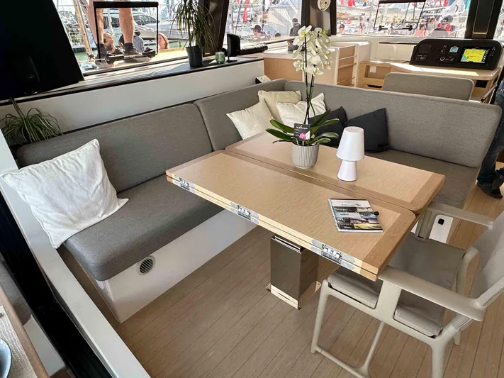  Yacht Photos Pics Modern NEEL 52 yacht interior with cozy seating, table, and decor, 2025 model.