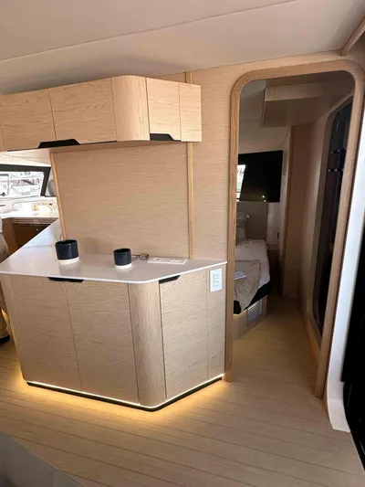  Yacht Photos Pics Modern interior of 2025 NEEL 52 yacht with sleek cabinetry and ambient lighting.