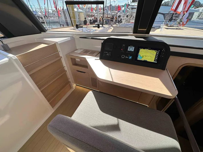  Yacht Photos Pics Modern NEEL 52 yacht interior with navigation system, wooden desk, and comfortable seating, 2025 model.