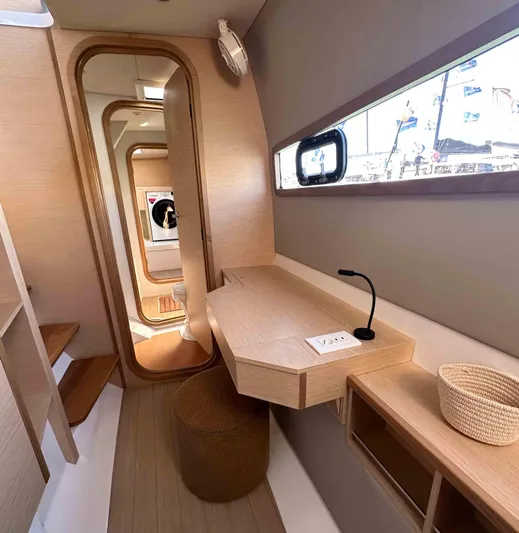  Yacht Photos Pics Modern interior of 2025 NEEL 52 trimaran with sleek design and natural wood finishes.