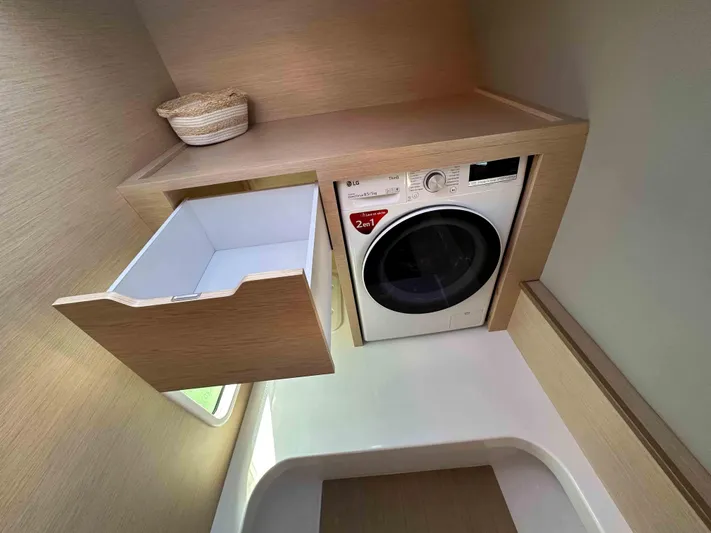  Yacht Photos Pics Laundry area in NEEL 52, 2025 model, featuring a washer and storage drawer.