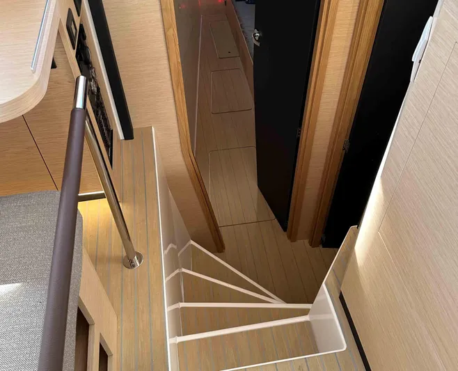  Yacht Photos Pics Interior of NEEL 52 yacht, 2025 model, featuring modern staircase and wooden finishes.