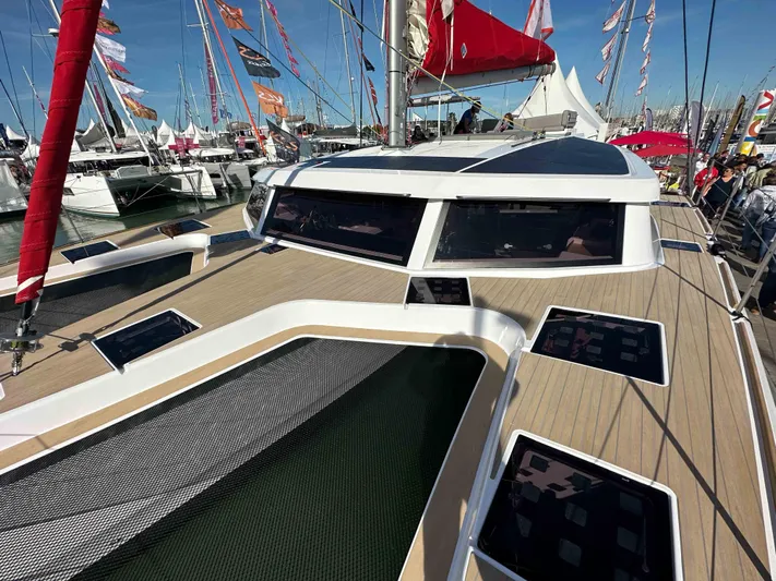  Yacht Photos Pics 2025 NEEL 52 trimaran at a boat show, showcasing sleek design and modern features.