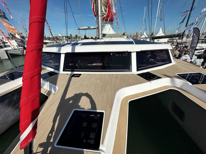  Yacht Photos Pics 2025 NEEL 52 trimaran at a boat show, showcasing sleek deck design and modern features.