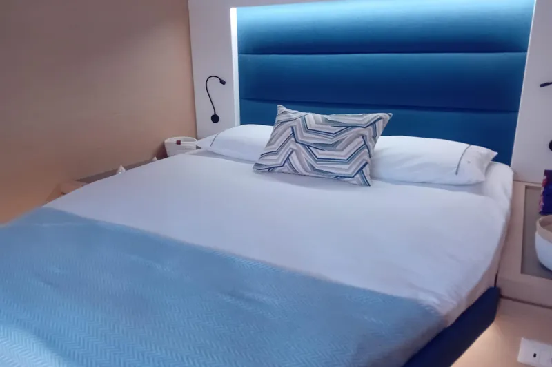  Yacht Photos Pics Luxurious bedroom interior of 2024 Fountaine Pajot Tanna 47 yacht with modern design.