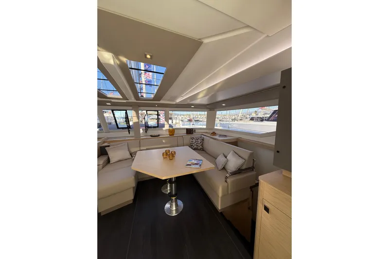  Yacht Photos Pics Luxurious interior of 2024 Fountaine Pajot Tanna 47 catamaran with spacious seating and modern design.