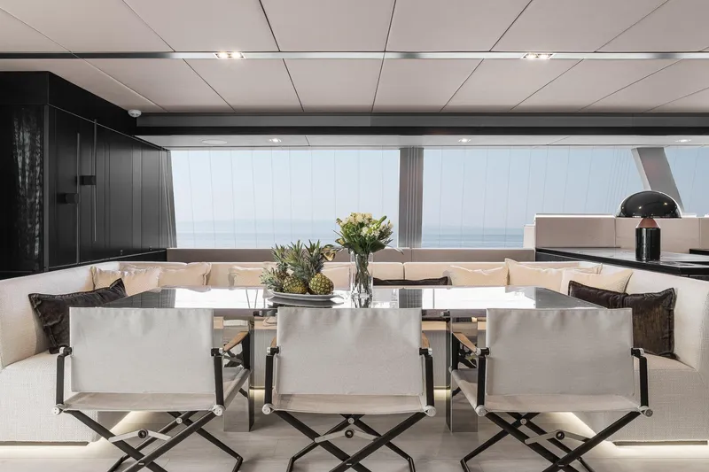 Yacht Photos Pics Luxurious interior of 2026 Sunreef 70 yacht with elegant dining area and ocean view.