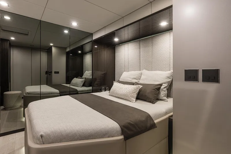  Yacht Photos Pics Luxurious bedroom interior on 2026 Sunreef 70 yacht, featuring modern design and elegant bedding.