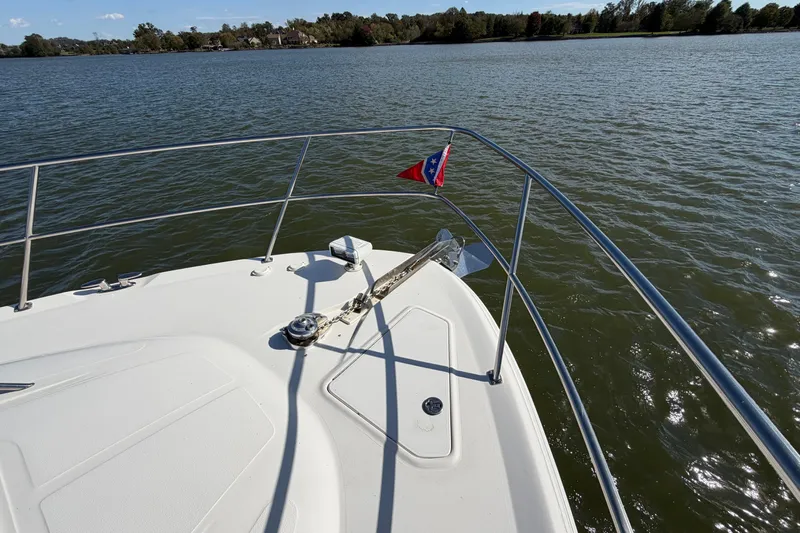 Gusto Yacht Photos Pics Bow view of 2003 Sea Ray 560 Sedan Bridge on a calm lake.