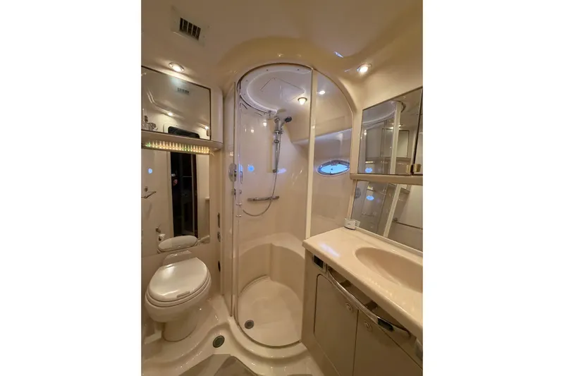 Gusto Yacht Photos Pics Luxurious bathroom in 2003 Sea Ray 560 Sedan Bridge yacht, featuring shower and vanity.
