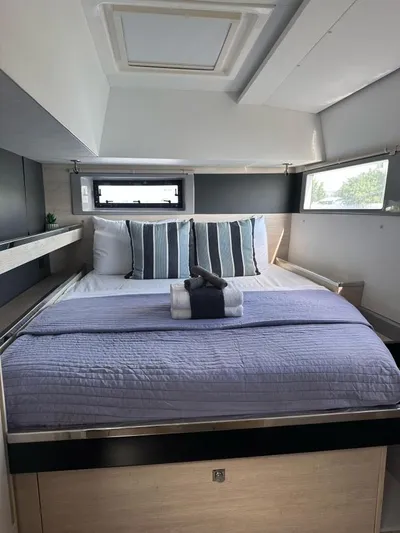 Nice Aft Too Yacht Photos Pics Cozy bedroom in a 2018 Leopard 45 yacht with striped pillows and skylight.