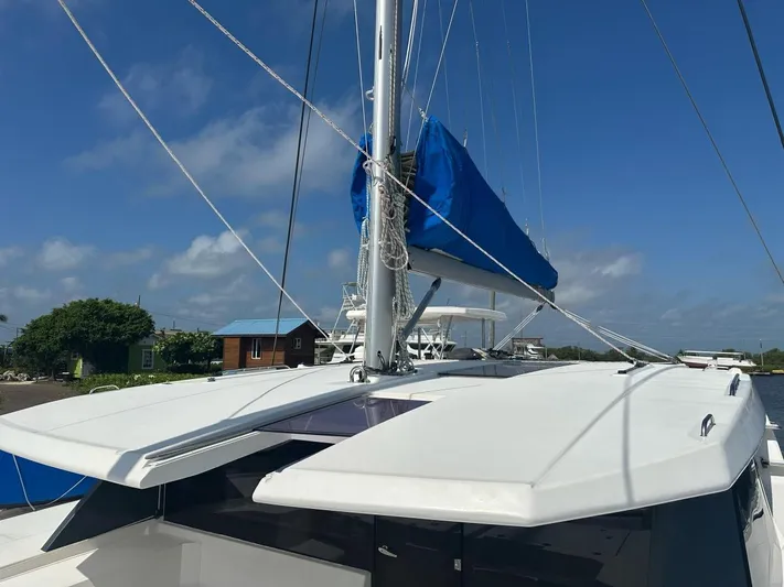 Nice Aft Too Yacht Photos Pics Sailing catamaran Leopard 45, 2018 model, with blue sail cover, docked under clear skies.