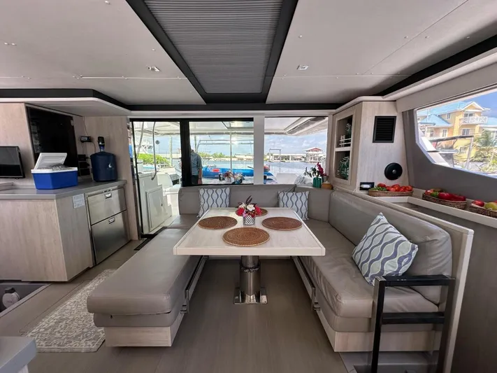 Nice Aft Too Yacht Photos Pics Luxurious interior of 2018 Leopard 45 catamaran with dining area and scenic marina view.