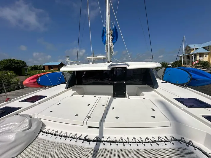 Nice Aft Too Yacht Photos Pics 2018 Leopard 45 catamaran deck with kayaks, under a clear blue sky.