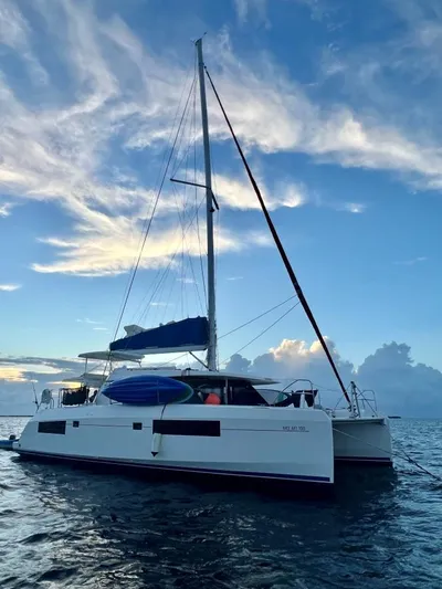 Nice Aft Too Yacht Photos Pics 2018 Leopard 45 catamaran sailing on calm waters at sunset.