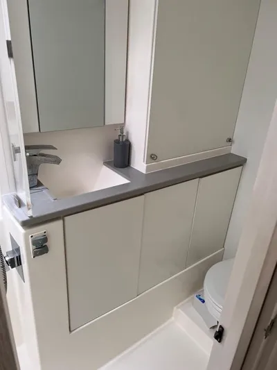 Nice Aft Too Yacht Photos Pics Compact bathroom in a 2018 Leopard 45 yacht, featuring modern fixtures and sleek design.