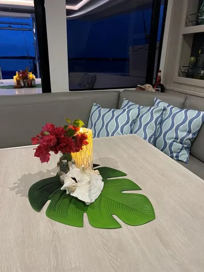 Nice Aft Too Yacht Photos Pics Cozy yacht interior with floral centerpiece, candle, and decorative pillows on a Leopard 45, 2018 model.