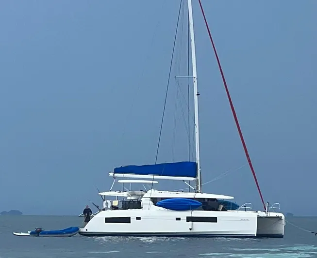 Nice Aft Too Yacht Photos Pics 2018 Leopard 45 catamaran with blue accents sailing on calm waters.