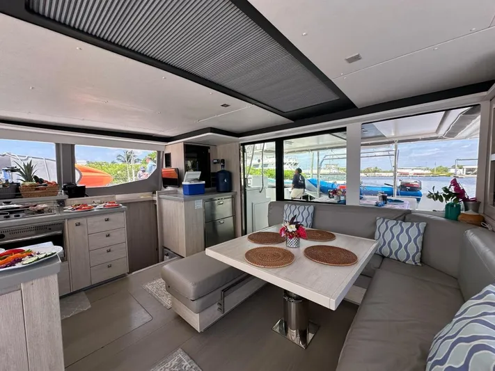 Nice Aft Too Yacht Photos Pics Luxurious interior of a 2018 Leopard 45 catamaran with modern dining area and scenic views.