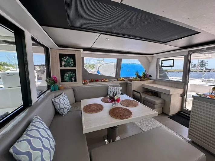 Nice Aft Too Yacht Photos Pics Luxurious interior of a 2018 Leopard 45 catamaran with elegant dining area and ocean view.
