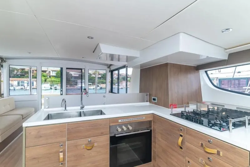 Dreamer Yacht Photos Pics Modern kitchen interior on 2022 Bali 4.6 yacht with wood cabinetry and large windows.