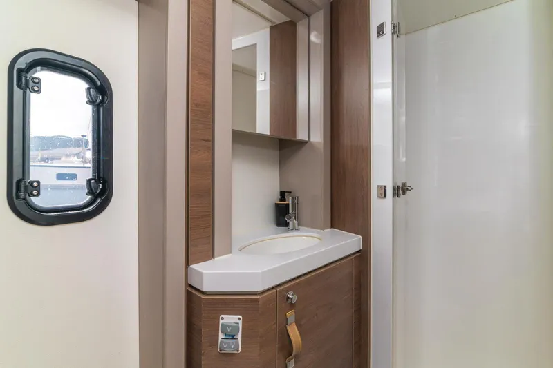 Dreamer Yacht Photos Pics Modern bathroom interior in 2022 Bali 4.6 yacht, featuring sleek wood cabinetry and compact design.