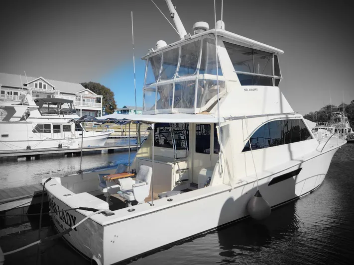 Boss Lady Yacht Photos Pics Ocean Yachts 48, 2001 model, docked at a marina with other boats in the background.