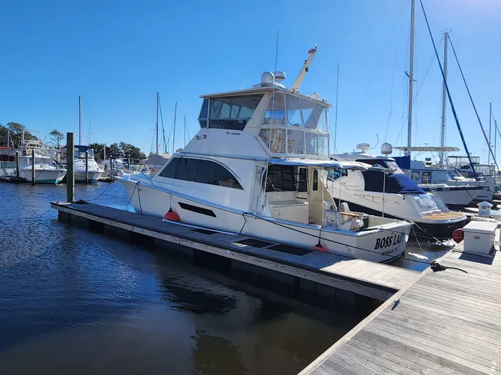 Boss Lady Yacht Photos Pics 2001 Ocean Yachts 48 docked at a marina on a sunny day.