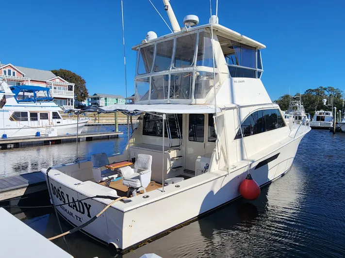 Boss Lady Yacht Photos Pics 2001 Ocean Yachts 48 model docked at a marina on a sunny day.