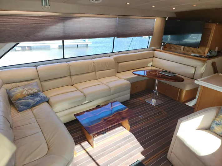 Boss Lady Yacht Photos Pics Luxurious interior of a 2001 Ocean Yachts 48 with cream leather seating and wooden accents.