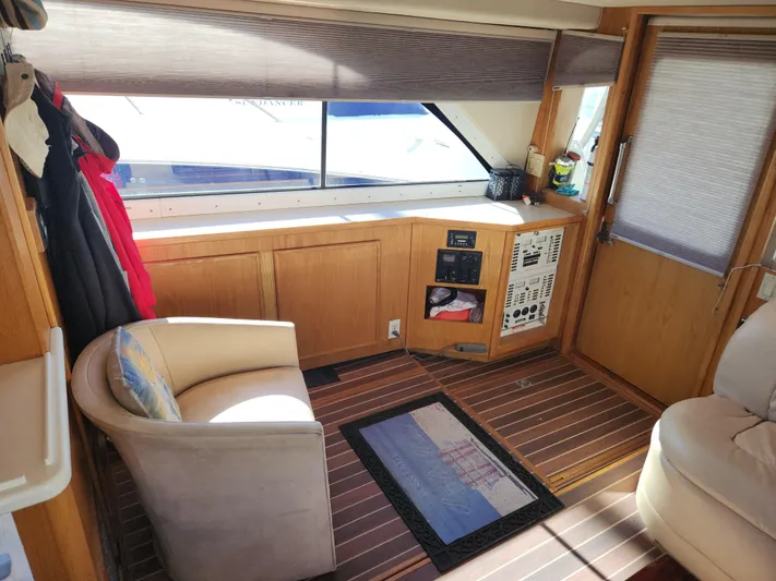 Boss Lady Yacht Photos Pics Interior of 2001 Ocean Yachts 48, featuring seating, control panels, and wooden flooring.