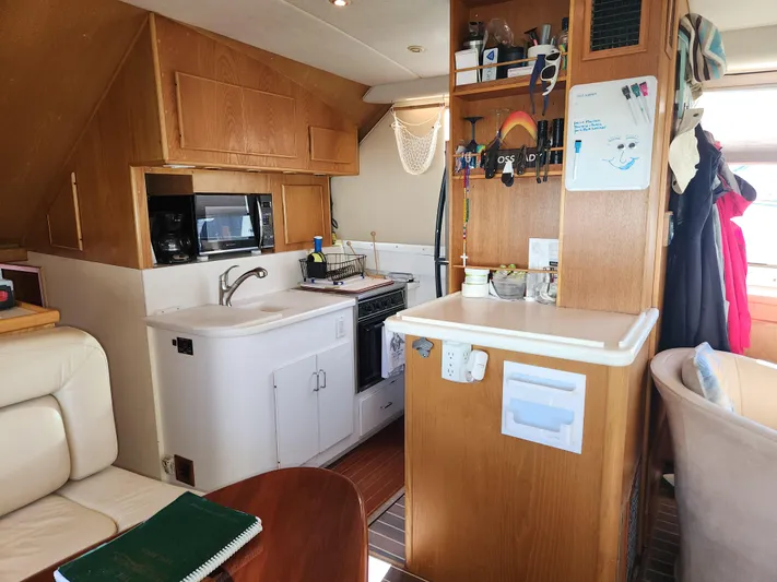 Boss Lady Yacht Photos Pics Interior of 2001 Ocean Yachts 48, featuring a compact kitchen with sink, microwave, and storage.