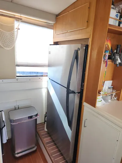 Boss Lady Yacht Photos Pics Kitchen area of a 2001 Ocean Yachts 48 with stainless steel fridge and trash bin.