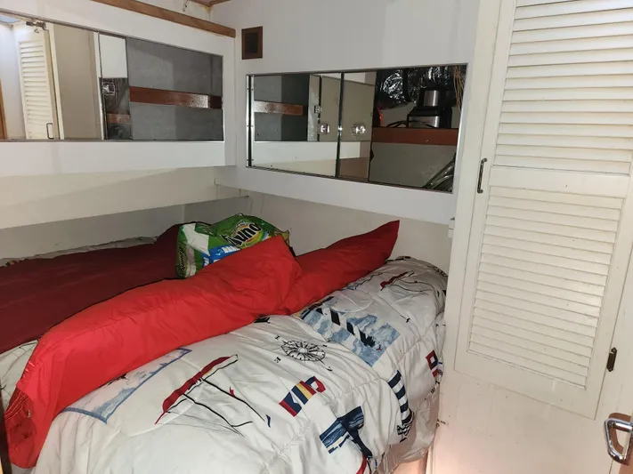 Boss Lady Yacht Photos Pics Cozy bedroom in a 2001 Ocean Yachts 48 boat with nautical-themed bedding.