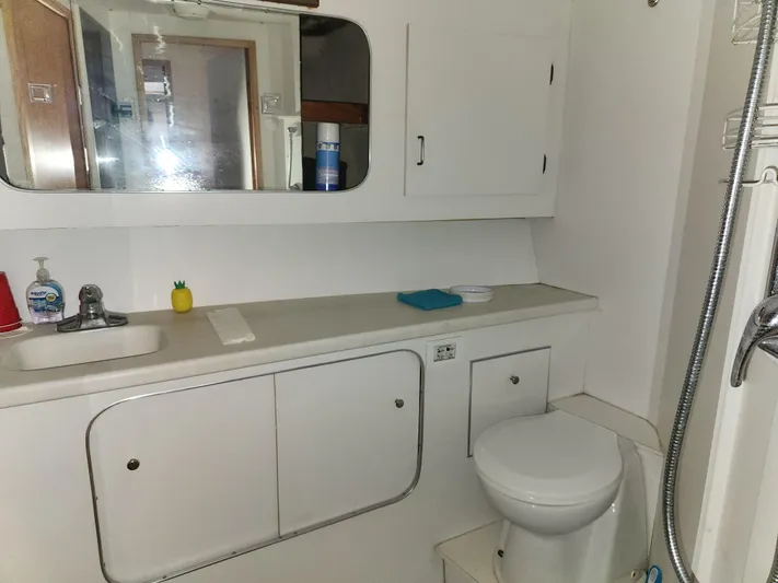 Boss Lady Yacht Photos Pics Bathroom interior of a 2001 Ocean Yachts 48, featuring sink, toilet, and storage cabinets.