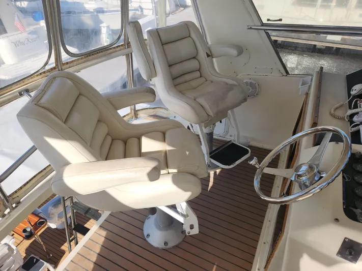 Boss Lady Yacht Photos Pics Captain's chairs and steering wheel on the 2001 Ocean Yachts 48 bridge deck.