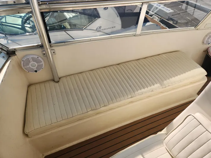 Boss Lady Yacht Photos Pics 2001 Ocean Yachts 48 interior seating area with cushioned bench and speaker.