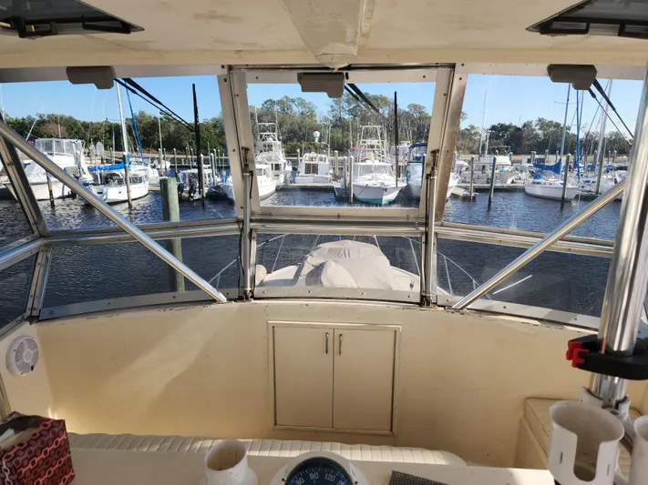 Boss Lady Yacht Photos Pics View from the cockpit of a 2001 Ocean Yachts 48, overlooking a marina with docked boats.