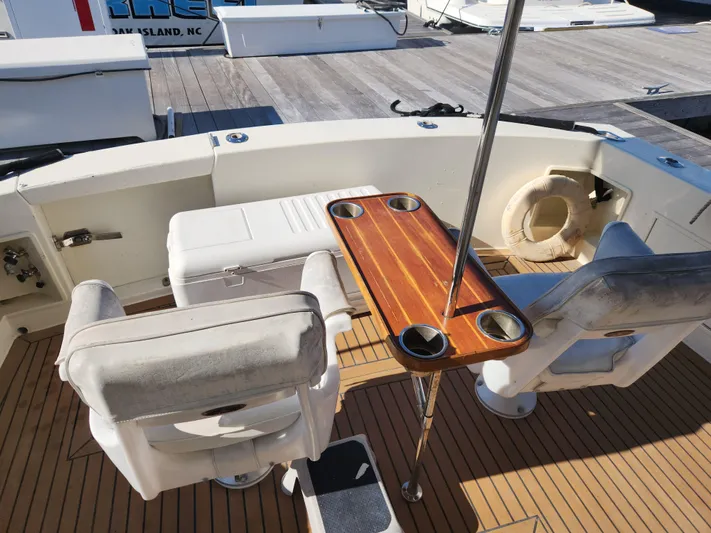 Boss Lady Yacht Photos Pics Cockpit of 2001 Ocean Yachts 48 with seating, table, and cooler.
