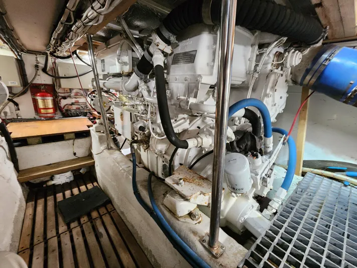 Boss Lady Yacht Photos Pics Engine room of a 2001 Ocean Yachts 48, showcasing mechanical components and fire extinguisher.