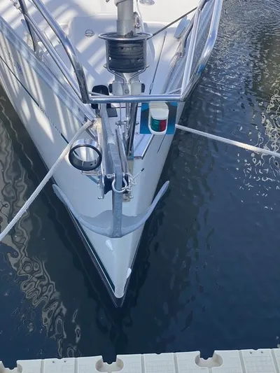 Axis Mundi Yacht Photos Pics Bow of 2002 Beneteau 393 sailboat docked, featuring anchor and navigation lights.